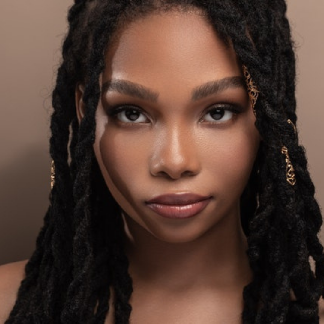 African american young lady with beautiful skin and dread locks.